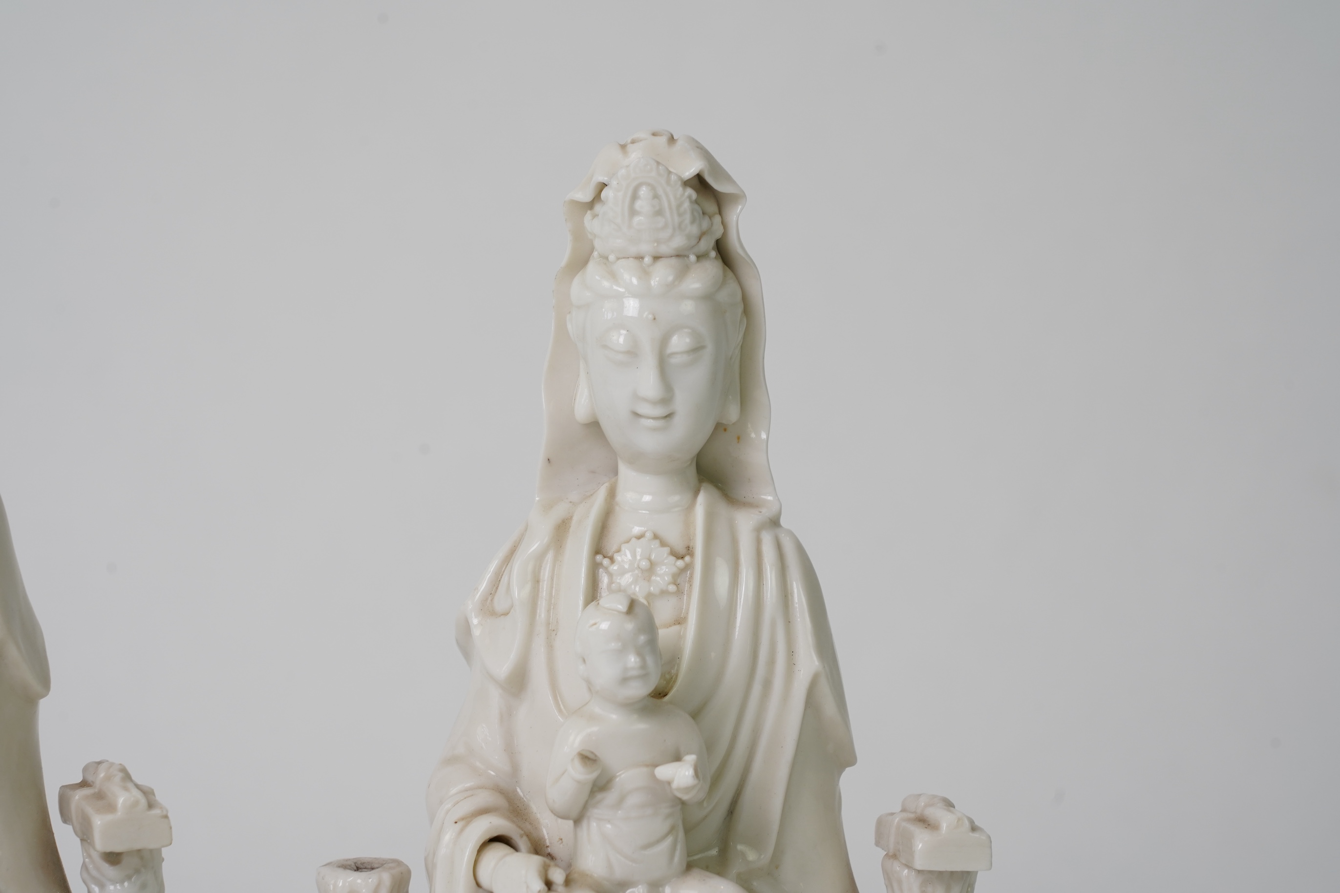 A pair of Chinese blanc de chine groups of Guanyin and children, 18th century